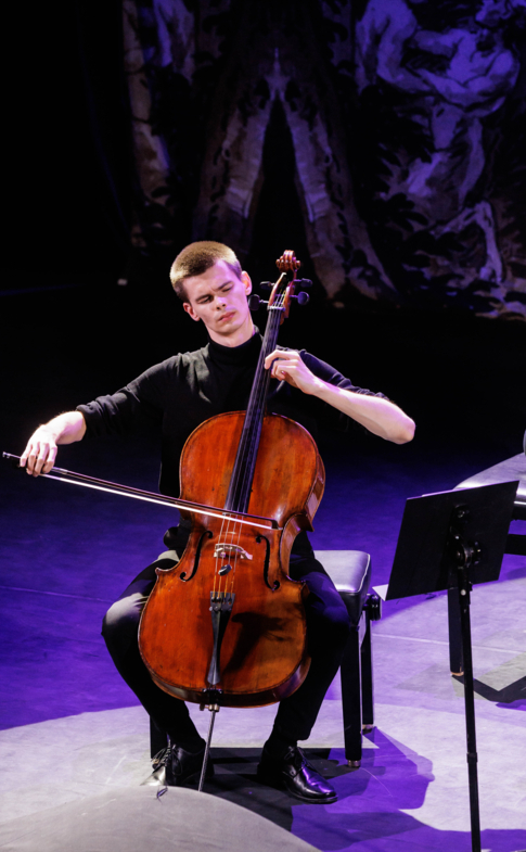Cellist and pianist performing together on stage at a Steinway & Sons grand piano.